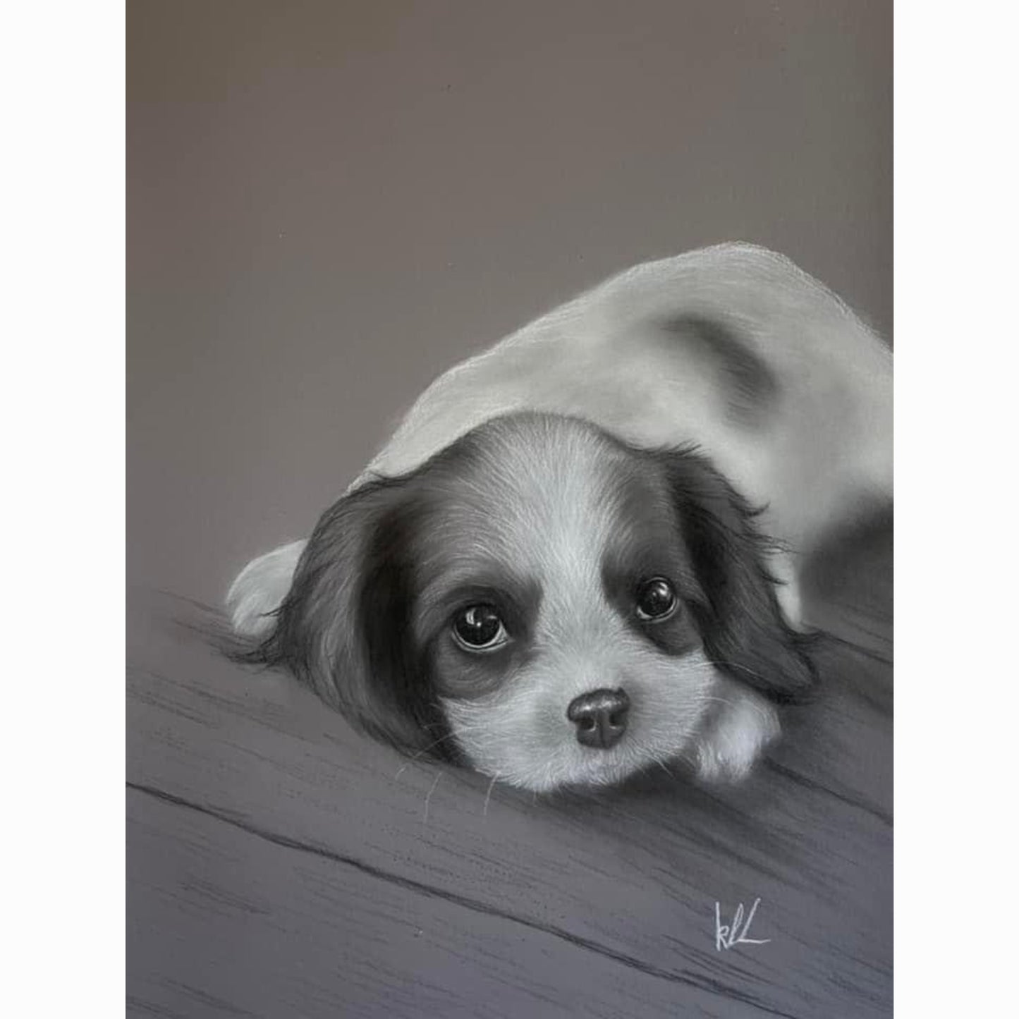 puppy lying on wood floor with eyes open